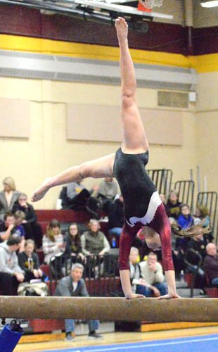 Emilee Otto executes a cartwheel on the beam during Stewie’s win over KM/Triton.