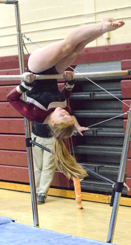Anna Myhre executes a pullover on the uneven bars during the Tigers win over the KoMets.