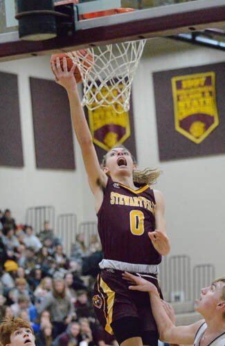 Nolan Stier attacks the rim, scoring two of his 12 points against Triton.