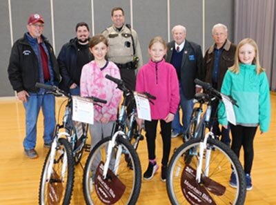 Three students at Bear Cave Intermediate School have each won a bicycle thanks to a program sponsored by the Stewartville Masonic Lodge and the Olmsted County Deputy Sheriffs Association. Student bike winners include, front row, from left, Destiny Hoffman, a fifth grader; Kayda Suess, fourth grader; and Avery Meyer, third grader. Standing in back, from left, are Doug Brick, past worshipful master and tyler of Stewartville Masonic Lodge No. 203; Jason Kennedy, senior warden at the Lodge; Jason Owen, Stewartvilles community oriented policing (COPS) deputy, representing the Sheriffs Association; Bill Hubbard, past worshipful master and chaplain of the Lodge; and Len Griffith, past worshipful master, treasurer and marshal at the Masonic Lodge.
