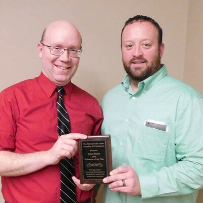 Robert Hruska, grocery manager of Fareway of Stewartville, left, accepts the Stewartville Area Chamber of Commerces Volunteer of the Year Award for 2019 from Mike Rainey of Bremer Bank, outgoing Chamber president.