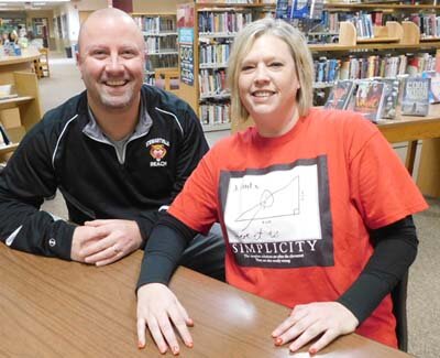 Jim Parry, REACH coordinator at Stewartville High School-Middle School, left, and Stephanie Affeldt, math teacher at Stewartville High School, have been nominated for Minnesota Teacher of the Year. The two are among the 134 teachers across the state nominated for the honor. Affeldt says she loves math. She wears math shirts, such as the one pictured above, tells math jokes and tries to sell the subject any way she can. Parry runs the REACH program, which offers personal assistance to a variety of students, many of whom have experienced adverse childhood experiences (ACE’s) at home.