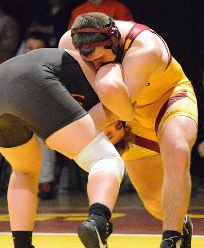 Parker Theobald locks arms and drives his 220-pound Lake City foe.