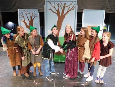 The Merry Men hope a romance blossoms between Robin Hood (Marcus Johnson), fourth from left, and Lady Marian (Lyndsey Rentz), fourth from right, during a dress rehearsal for Stewartville Middle School’s upcoming production of The Somewhat True Tale of Robin Hood. The cast and crew will present the play at the Stewartville High School Performing Arts Center on Friday, Feb. 14 and Saturday, Feb. 15 at 7 p.m. each evening and on Sunday, Feb. 16 at 2 p.m.