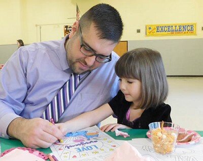 John Angeli and his daughter Alice, 5, a preschooler at the Central Education Center, work together on a drawing at the annual Stewartville Community Education Daddy-Daughter Dance on Saturday, Feb. 8.