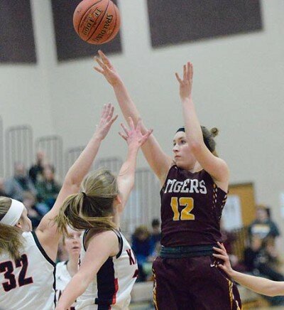 Lily Welch has two hands in her face and is shoved in the hip, but she connects on this 14-foot jumper to become the all-time leading scorer in Stewartville girls basketball history.