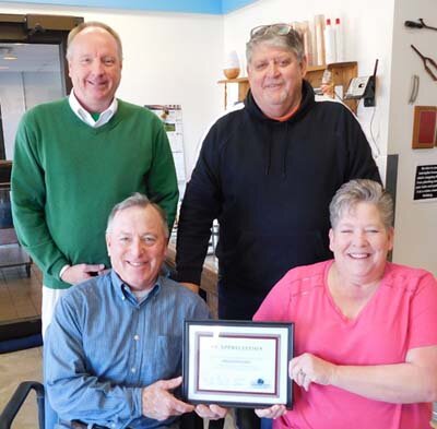 Wendy Meyerhofer, owner of Shear Perfections, seated at right, accepts the Economic Development Authority’s Business Appreciation Award from, clockwise from lower left, Mayor Jimmie-John King, a member of the EDA; Bill Schimmel Jr., city administrator; and Jim Kuisle, president of the EDA.