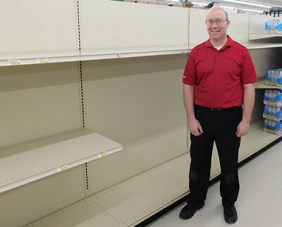 Robert Hruska, grocery manager at Fareway, Stewartville’s grocery store, stands near the shelves emptied of toilet paper and paper towels last week. Shoppers concerned about the spread of the COVID-19 virus quickly bought all the store’s toilet paper, paper towels, hand sanitizer and more.