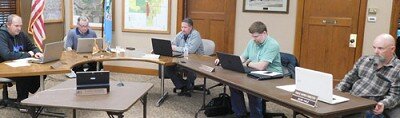 Meeting at City Hall on Wednesday evening, March 25, the Stewartville City Council and staff, mindful of the social distancing guidelines to reduce the spread of the coronavirus (COVID-19), seated themselves six feet apart from each other. Above, from left, are Councilperson Brent Beyer, Mayor Jimmie-John King, councilpersons Craig Anderson and Jeremiah Oeltjen, and Sean Hale, public works director.