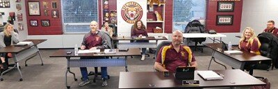 Members of the Stewartville School Board, mindful of the social distancing guidelines to reduce the spread of the coronavirus (COVID-19), seated themselves a considerable distance from each other at the Board’s regular meeting on Monday evening, March 23. Members include, in front, Todd Emanuel. Second row, from far left, Lori Miller-Beach, Will Welch, Nichol O’Neill and Ryan Ravenhorst. In back, Rebecca Wortman, board chair. Board member Dean Mikel was absent. Also in back, Tristan Knight, a Boy Scout from Troop 56, Stewartville, attended the meeting to earn a merit badge in community involvement. At last week’s meeting, the School Board approved a recommendation from Superintendent Belinda Selfors and Wortman stating that, due to the declared health pandemic, all School Board meetings beginning on Monday, April 13 will be held by teleconference or other electronic means. “In-person meetings of the Stewartville School Board are not practical or prudent because of a health pandemic or an officially-declared emergency,” the recommendation states. At future meetings, Selfors and Wortman will be stationed at the Central Education Center, with all other School Board members communicating electronically from home.