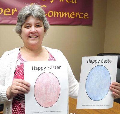 Myrna Welter, membership coordinator for the Stewartville Area Chamber of Commerce, displays samples of Easter Egg drawings that will be placed on the windows of local businesses during the Chambers Easter Egg Hunt April 10-14.