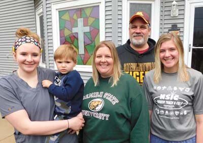 On Palm Sunday, a Stewartville family worked together to paint a cross on the east window of their house at 307 First Street East. Workers included Tom Passe, second from right, and Molly Christenson, third from right, their daughters, Abby Christenson, far left, and Libby Christenson, far right, along with Abby’s son Liam, 3, held by his mother. “I got the idea from some co-workers,” Molly said. “We decided on the cross because it’s Easter.”