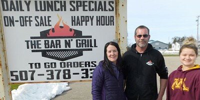Bobby and Angela Carr, co-owners of Carrís Bar Ní Grill of Racine, center and left, and Abby Lee, a waitress, right, are grateful that a number of area businesses and organizations have paid their restaurant-bar to provide free meals to health care workers and others.