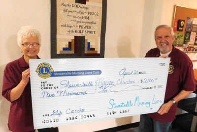 Char Weichmann, treasurer of the Stewartville Morning Lions Club, left, and Dave Hoot, the clubs president, display a $2,000 check representing the amount the club donated to eight Stewartville churches, one church in Racine and one in Pleasant Grove.