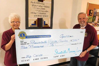 Char Weichmann, treasurer of the Stewartville Morning Lions Club, left, and Dave Hoot, the club’s president, display a $2,000 check representing the amount the club donated to eight Stewartville churches, one church in Racine and one in Pleasant Grove.