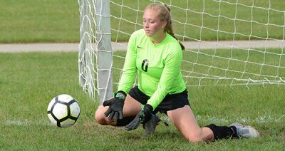 Goalkeeper Ava Myhre hustles to the post to make a scoop save.