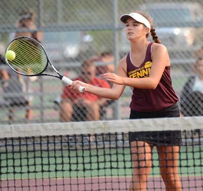 Mya Wangen makes a return while playing at the net on the No. 2 doubles court.