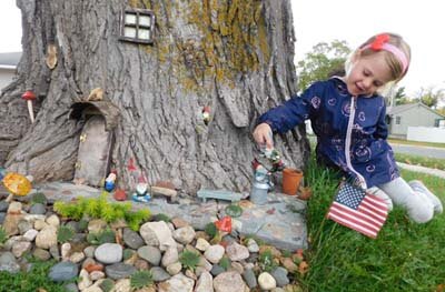 Theres no place like gnome -- Avery Struckmann, 4, of Racine, plays at the little gnome village built by Jennifer Crace and Paul Grafe of Stewartville.