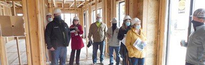 Jeremy Kane, construction manager for Schoeppner Construction, the company building the new Flats 55 apartment building, far left; and Darren Groteboer, a partner with PGGM1, LLC, the developer for the project, far right; led Stewartville city officials on a tour of the complex under construction near Bear Cave Intermediate School on Oct. 1. City leaders include, in back, from left, Bill Schimmel Jr., city administrator; Heather Holmes of CEDA of Chatfield; Sean Hale, public works director; Mayor Jimmie-John King; Karla Strain, finance director; and Cheryl Roeder, city clerk.