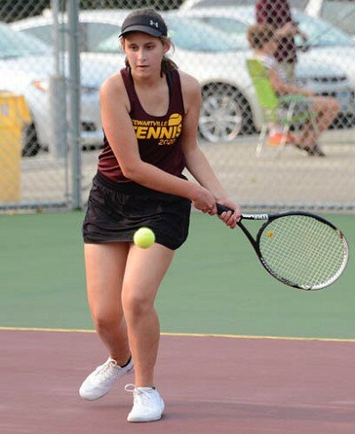 Grace Miller uses quick footwork and charges from the baseline to blast this backhand return.