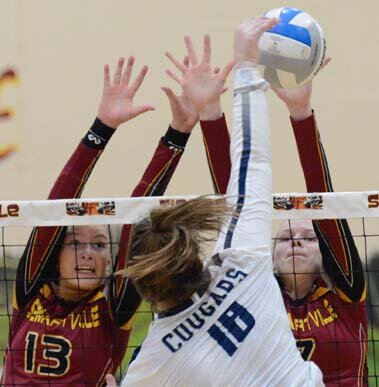 Erin Lamb (#13) and Ariana Blohm block this Cougar attack during Stewie’s 3-0 sweep of ZM.