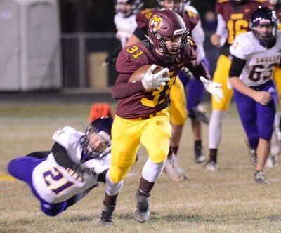 Running back Owen Sikkink receives a pass in the flat, sheds a Lourdes defender and breaks free in the open field for a big gainer.