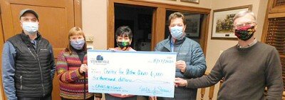 After Sharon McAtee, site coordinator at the Stewartville Center for Active Adults, center, asked God for help to keep the Center open, the city of Stewartville’s Economic Development Authority, represented by Adam Wright, far left, presented McAtee and the Center a $6,000 check in CARES Act funding last week. Others in the photo include Anita Wendt, the Center’s finance reporter, second from left; along with Gene Gustason, second from right, and Pastor Byron Meline, far right, members of the Center for Active Adults Board.