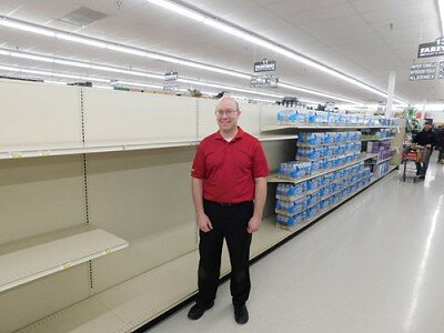 Robert Hruska, grocery manager at Fareway, stands near the shelves emptied of toilet paper and paper towels in mid-March. Shoppers concerned about the spread of the COVID-19 virus quickly bought all the stores toilet paper, paper towels, hand sanitizer and more.
