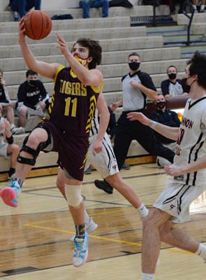 Ben Trenary attacks the rim on this scoop for the hoop against Cannon Falls.