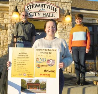 Lexi Williams of Community Economic Development Associates (CEDA), foreground, worked with members of the Stewartville Area Community Foundation, including Al Chihak, left, and Lisa Lonien, right, to schedule a series of Wednesday evening summer concerts at the new Bear Cave Amphitheater beginning on June 16. Aaron Simmons, a Stewartville native and an accomplished singer-songwriter, heads the list of performers.