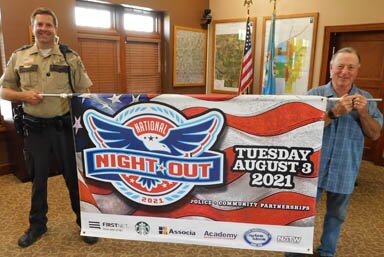 National Night Out, an annual community-building campaign that promotes police-community partnerships and neighborhood camaraderie to make neighborhoods safer, more caring places to live, will be held in Stewartville on Tuesday, Aug. 3. Jason Owen, Stewartvilles community oriented policing (COPS) deputy, left, and Mayor Jimmie-John King hold the banner announcing the event.