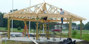 Workers are making steady progress on the new Veterans Memorial Park near Stewartvilles south entrance. Volunteer workers, such as those pictured above, have installed trusses for the octagon picnic shelter and are working on the buildings roof.