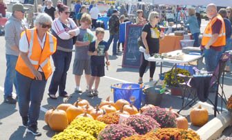 The Stewartville Morning Lions Club sold plenty of pumpkins and mums at the Club’s annual Fall Festival on Saturday, Sept. 18. Morning Lions members Sheila Majerus, left, and Brian Bushman, wearing the orange vests, welcomed many visitors to the Club’s sales area.