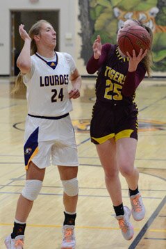 Keeley Steele drives from the wing, beating a Lourdes defender for a layup bucket.