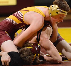 Tanner Elzen works for wrist control during his 138-pound match.