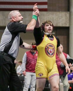 The referee signifies victory by raising Christian Sakett�s arm after he won the 220-pound 1AA championship title. photo by Sarah Sexton