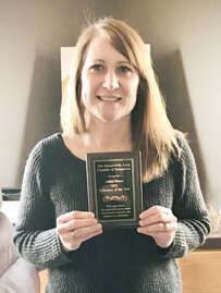 Alisha Nelson displays the plaque she received for being named the Stewartville Area Chamber of Commerce�s Volunteer of the Year for 2021. The plaque states, �With appreciation for consistently going above and beyond to promote and enhance our community.�