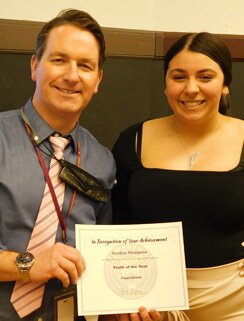 Aryahna Thompson, a senior at Stewartville High School, accepts a certificate from Patrick Breen, principal of SHS, declaring, �In recognition of your achievement for being selected by the Boys & Girls Club of Rochester as their Youth of the Year.�