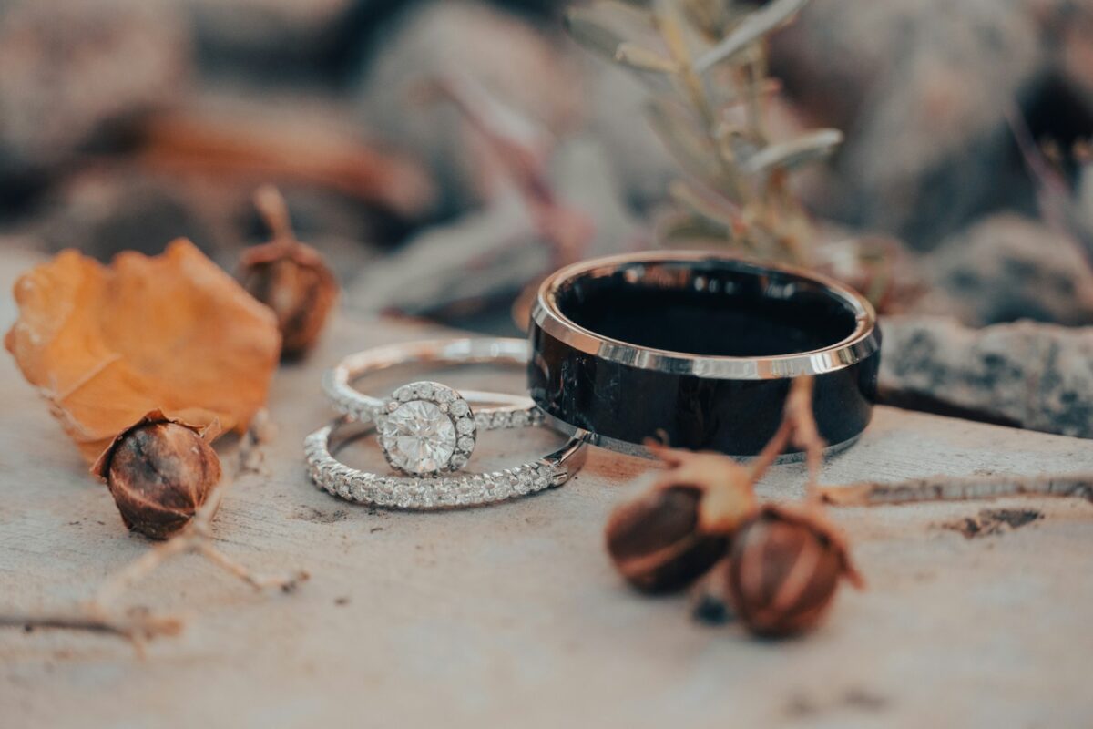 a couple of wedding rings sitting on top of a rock